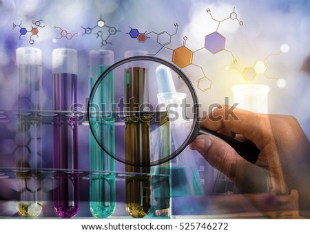 Laboratory test tube,Glass laboratory chemical test tubes with liquid and hand holding magnifier.Double exposure