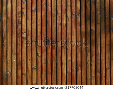 Background texture, Advertising surface of reddish round wood palisades or privacy fence