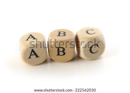 abc, spelled with wooden alphabet blocks, education toy to learn reading and writing, isolated on white background