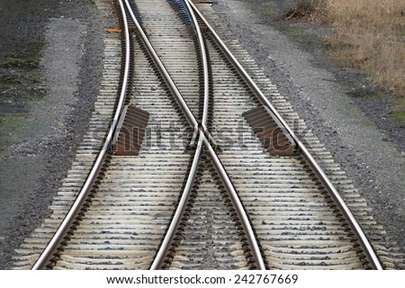railroad tracks with railroad switch, two paths come together