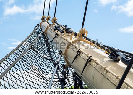 bowsprit and safety net of a historic Tall Ship against the blue sky