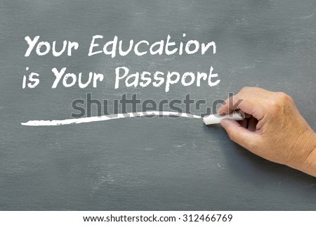 Hand on a chalkboard with the words Your education is your passport. Education class concept showing teacher hand writing on the blackboard.