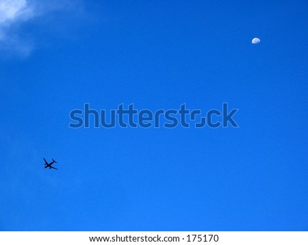 Plane in a blue sky with the moon