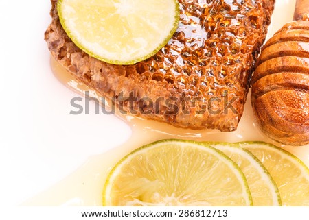 Honey, Honeycomb and Slice of Lemon on White Background. Herbal Product.