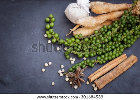 Colorful spices and herbs on a black wooden background.Herb food.