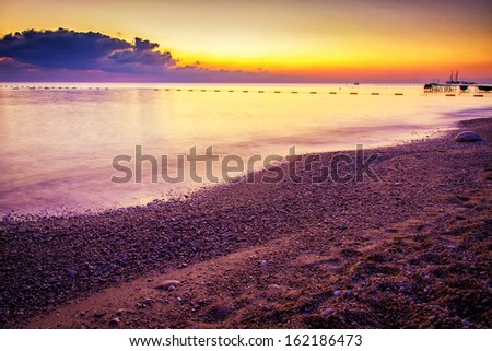 Beautiful landscape. Ocean beach during colorful sunset.