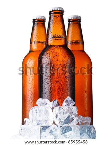 Three brown bottles of beer with ice isolated on white background
