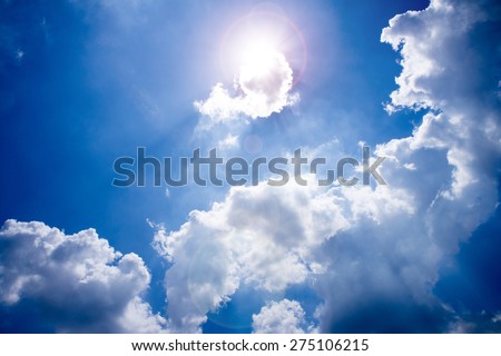Sun shining through the clouds look quaint small cubes,the sun causing lens flare