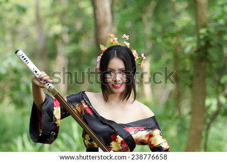 portrait Asia Beautiful Japanese kimono woman and Japanese geisha woman with Japanese sword and Woman with japan sword katana in hands