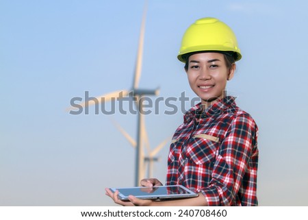 portrait women asia engineer working with a tablet at wind turbine farm Power Generator Station
