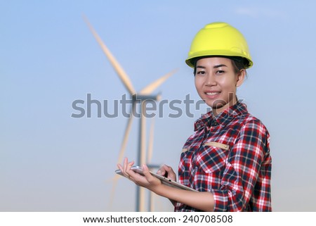 portrait women asia engineer working with a tablet at wind turbine farm Power Generator Station