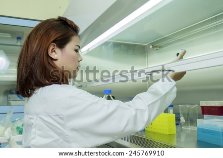 Young female tech or women science working and holding pipette in biological laboratory