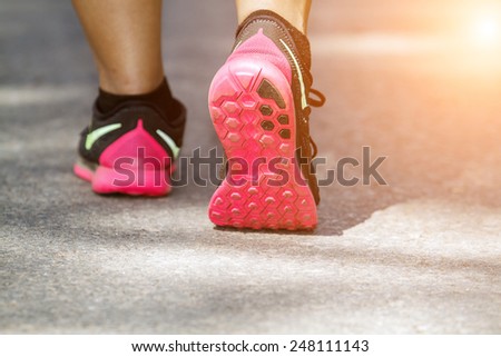 Athlete runner feet running on road closeup on shoe. woman fitness  jog workout on road