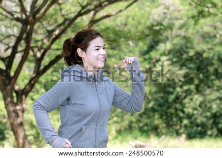 Running woman. Female runner jogging during outdoor on road .Young mixed race girl jogging in fall colors.