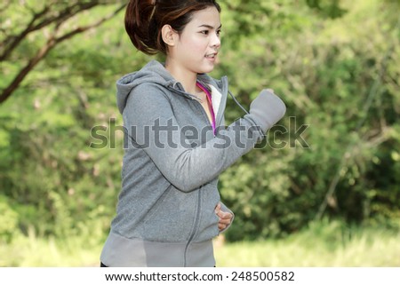 Running woman. Female runner jogging during outdoor on road .Young mixed race girl jogging in fall colors.