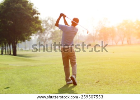 blurred golfers hit sweeping and keep golf course in the summer  for relax time
