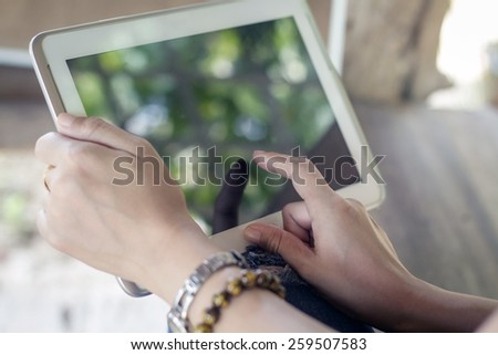 close up asia women using tablet at outdoor for relax time