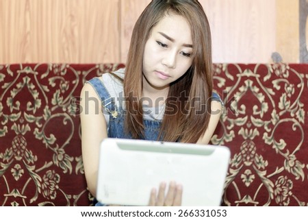 close up Asia women using tablet at sofa for relax time