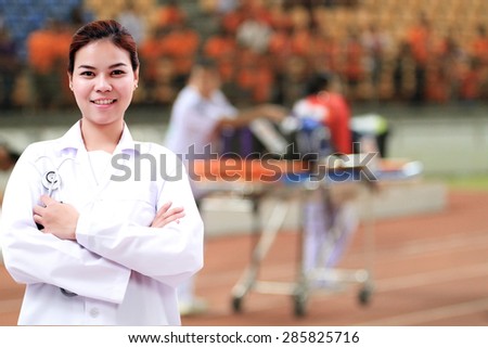 Smiling medical doctor woman Asia with stethoscope on  Stretcher and hospital trolley background