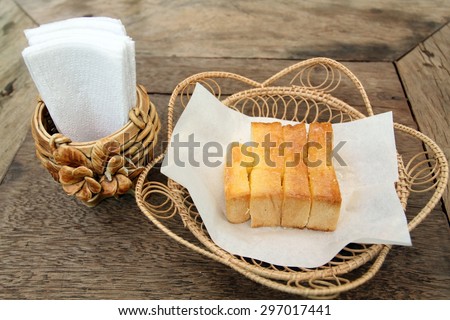 tissue paper and Bread, butter, topped milk  in wood Box on table
