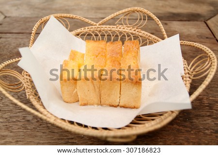 tissue paper and Bread, butter, topped milk in wood Box on table
