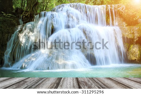Huay Mae Kamin Waterfall and wood floor Kanchanaburi Province. Thailand on sunlight