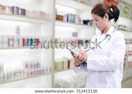 pharmacist chemist and medical doctor woman asia with stethoscope and clipboard checking medicine cabinet and pharmacy drugstore .