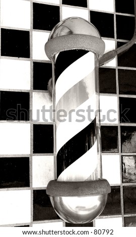 Old fashioned barber poll in black and white on a ceramic tile background
