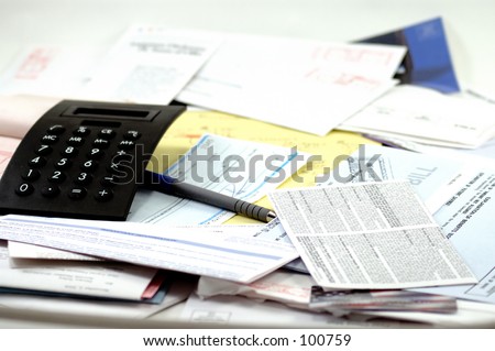 Calculator, legal pad and receipt book, paycheck and lots and lots of bills