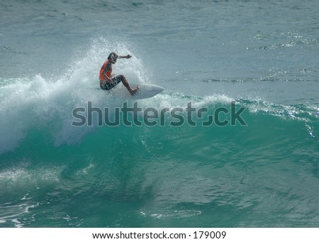 Surfer cutting back across the crest of the wave