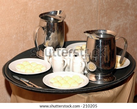 Waiters tray filled with water, cream and butter