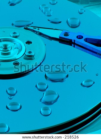 Droplets of water on the platers of an open hard drive