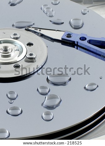 Droplets of water on the platers of an open hard drive