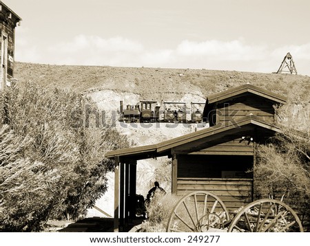 Steam engine powered narrow gauge rail car chugs through the hills of the desert mining town of Calico