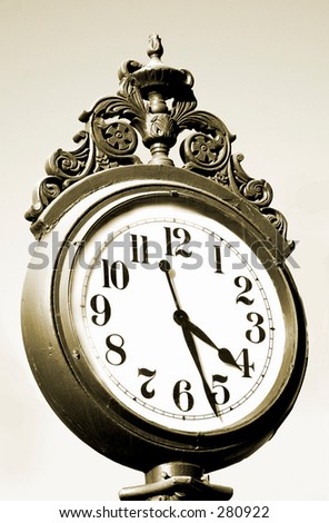 Sepia tone image of an antique street clock