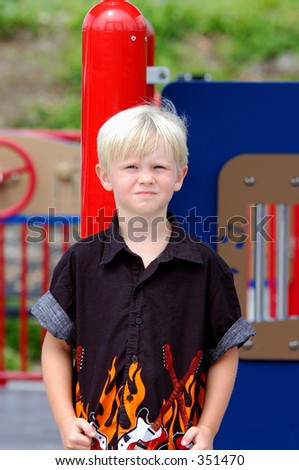 Blond boy child in a rock and roll flame shirt