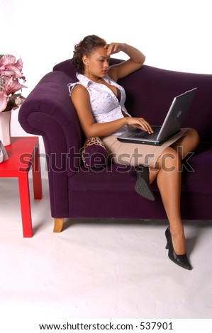 Beautiful woman on the couch with a laptop computer