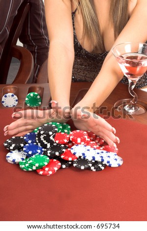 Detail of a womans hands placing an All In bet in a Texas Holdum Poker game