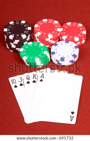 One of the highest hands in poker a Spades Royal Flush on a red felt gaming table with chips in the background  Ace of spades is blank for your logo