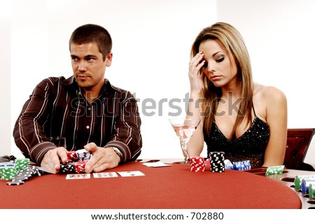 A sexy young couple playing out a hand of Texas Holdum laid out on a casino table Card backs are a digitally created design