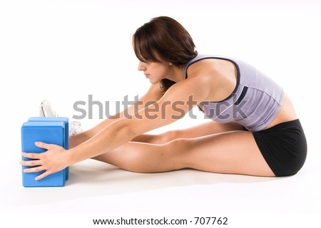 A woman stretches on Yoga blocks