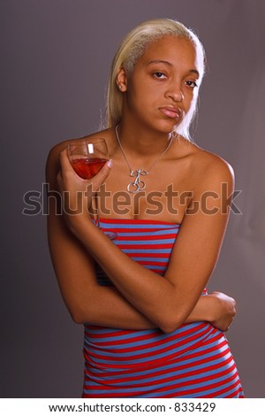 Sexy African American woman with long blond hair and a Honey complexion in a casual fashion with a glass of wine