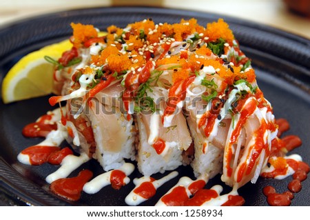 Tataki Special Sushi Roll. Spicy tuna in sushi rice with seared albacore, chopped onions, smelt roe, chili and mayonaise sauce