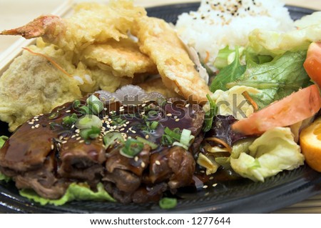 Combo Teriyaki combo plate with tempura shrimp, tempura vegetables and an Asian soy ginger salad, steamed rice and oranges