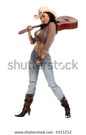 stock photo Super sexy rodeo cowgirl in torn jeans boots and cowboy hat 