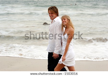 Two People Holding Hands On The Beach. two people holding hands