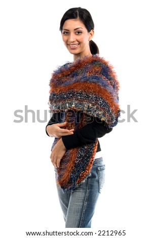 Beautiful young Mexican woman in jeans and a black shirt and a couture feather wool and angora shawl in umber, blue and grey yarns