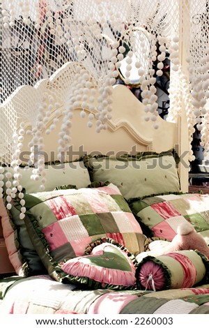 Detail of the head board and canopy of a canopy bed at an outdoor flea market