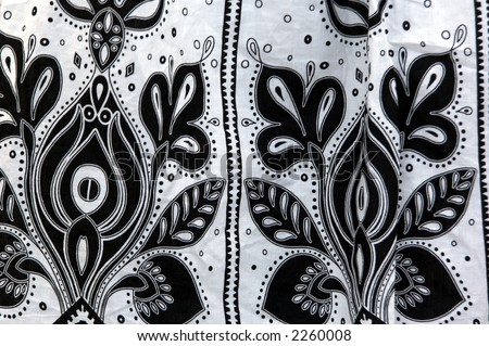 close up detail of a swatch of black and white paisley print fabric