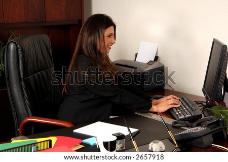 Female executive typing at her personal computer
